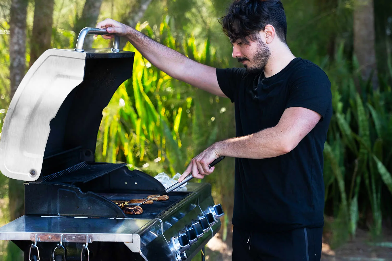 Resident grilling outdoors during a community cookout