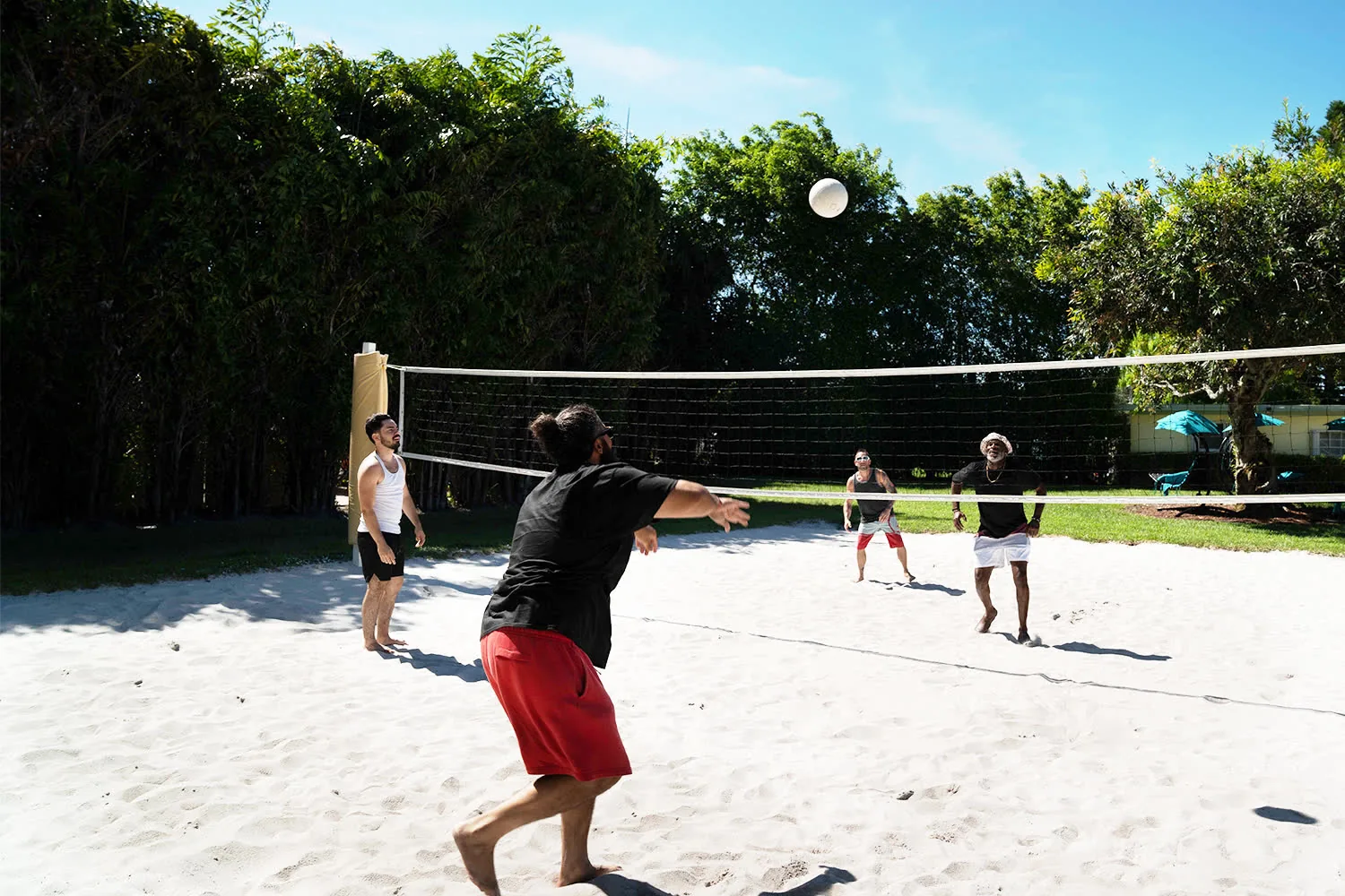 Residents playing beach volleyball on the property