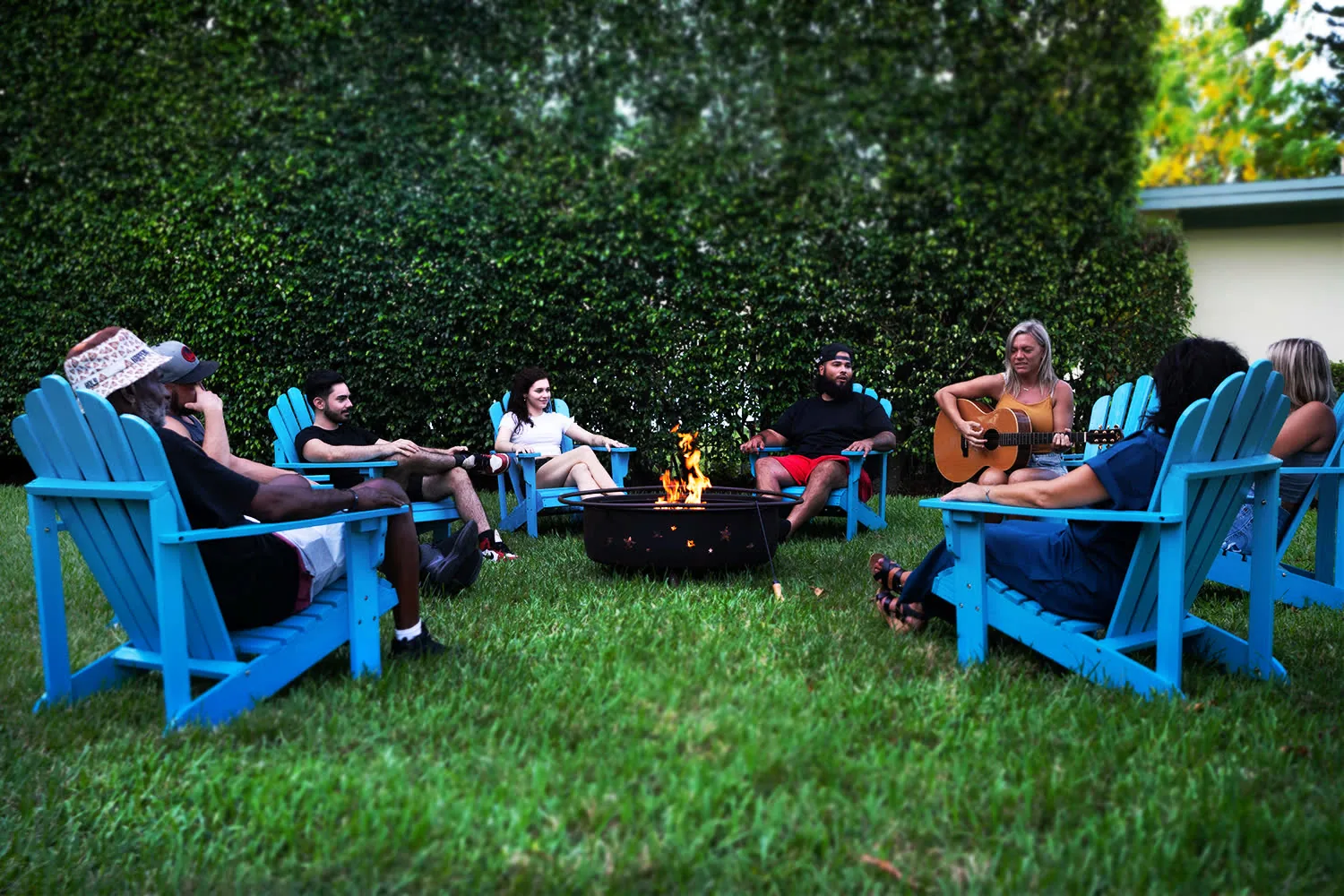 Residents gathered around a fire pit at sunset